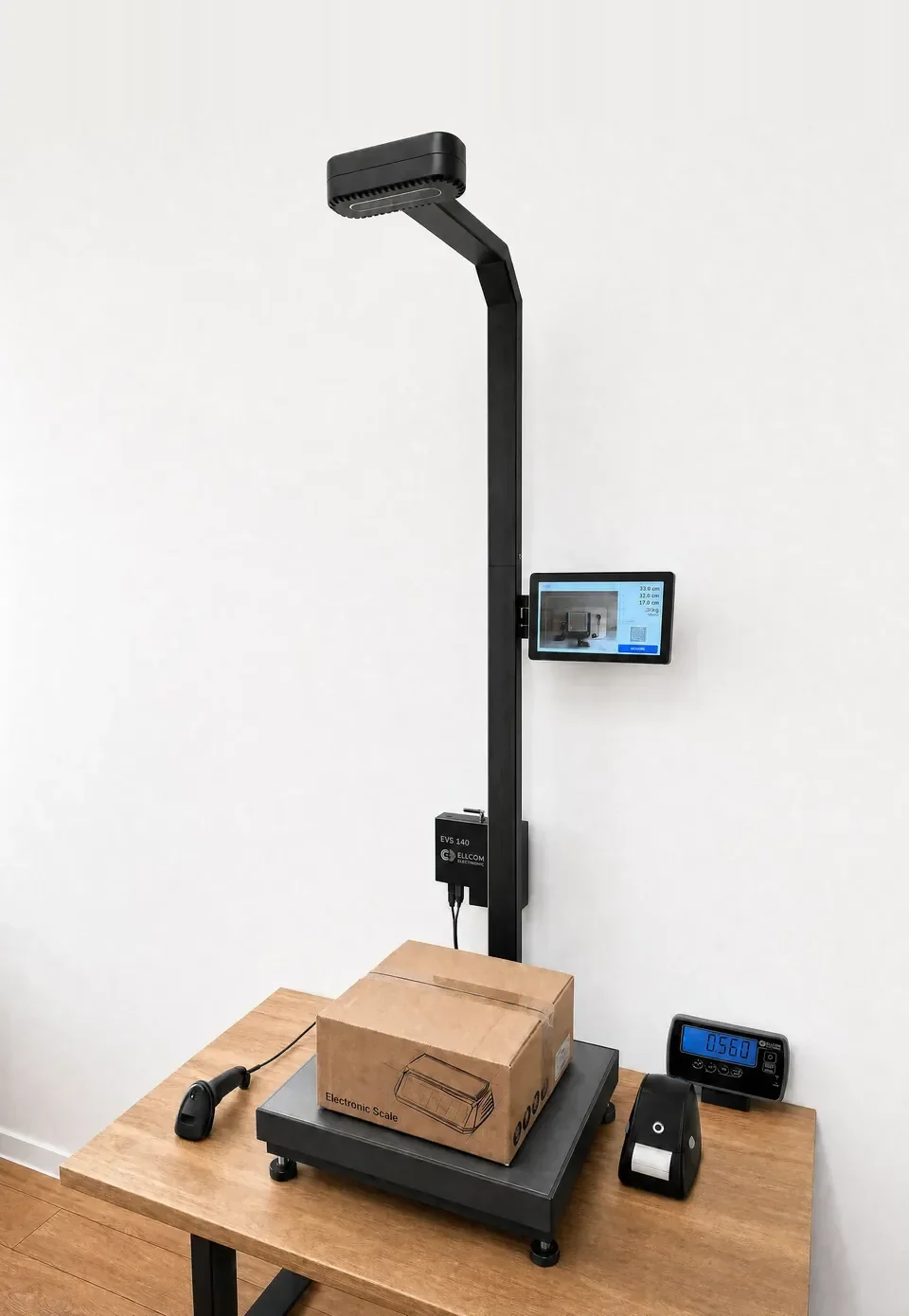 EVS 140: an overhead 3D sensing head on a slim black column with a touch display, above a platform scale holding a parcel, with a barcode scanner and label printer beside it.