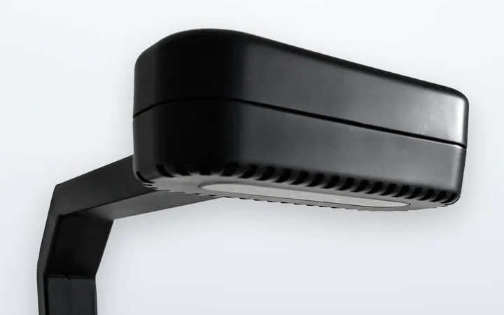The EVS 140 3D sensing head: a matte black housing on the column’s arm, with the sensor window on its underside.